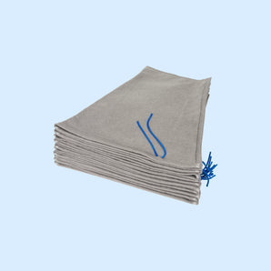 Filtersack Schmutzfangeimer aus grauem Vliesmaterial mit blauer Kordel als gefalteter Stapel dargestellt Filtersack Schmutzfangeimer aus grauem Vliesmaterial mit blauer Kordel als gefalteter Stapel dargestellt